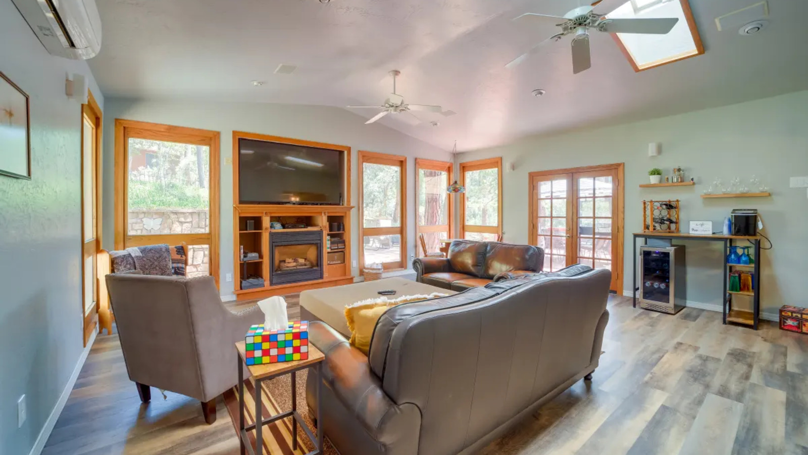 Great room with sofas, games, and tall windows.