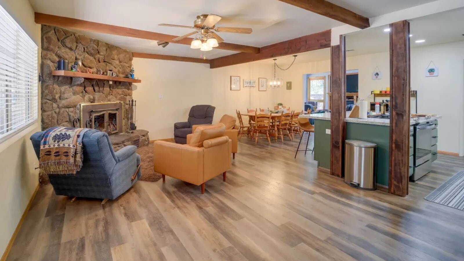Main living room with stone fireplace and warm seating.