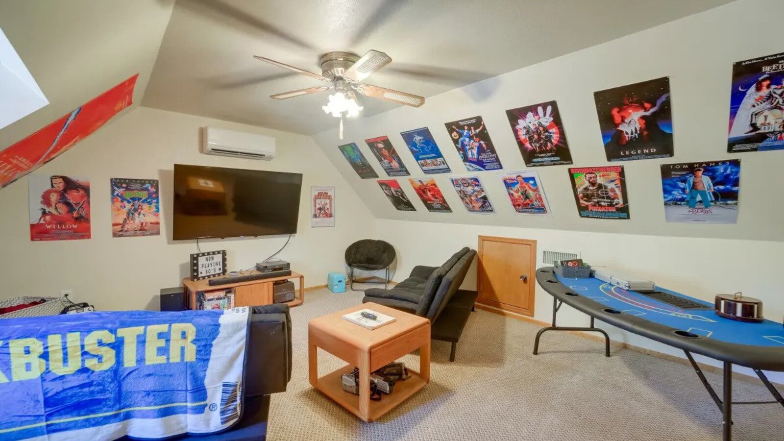 Movie room with posters, seating, and retro decor.