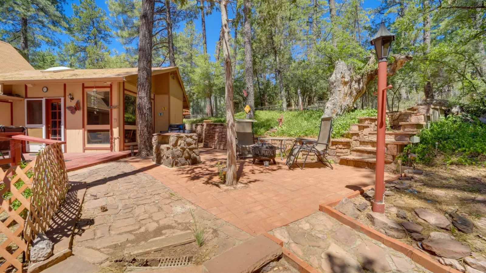 Backyard patio and wooded outdoor space.